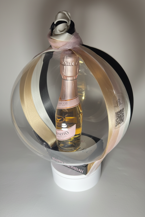 Bottle Bubble. This elegant gift turns  your bottles of choice into a stunning floating centerpieces. Ribbons of various colors gather at the top in a delicate bow, adding a graceful touch.